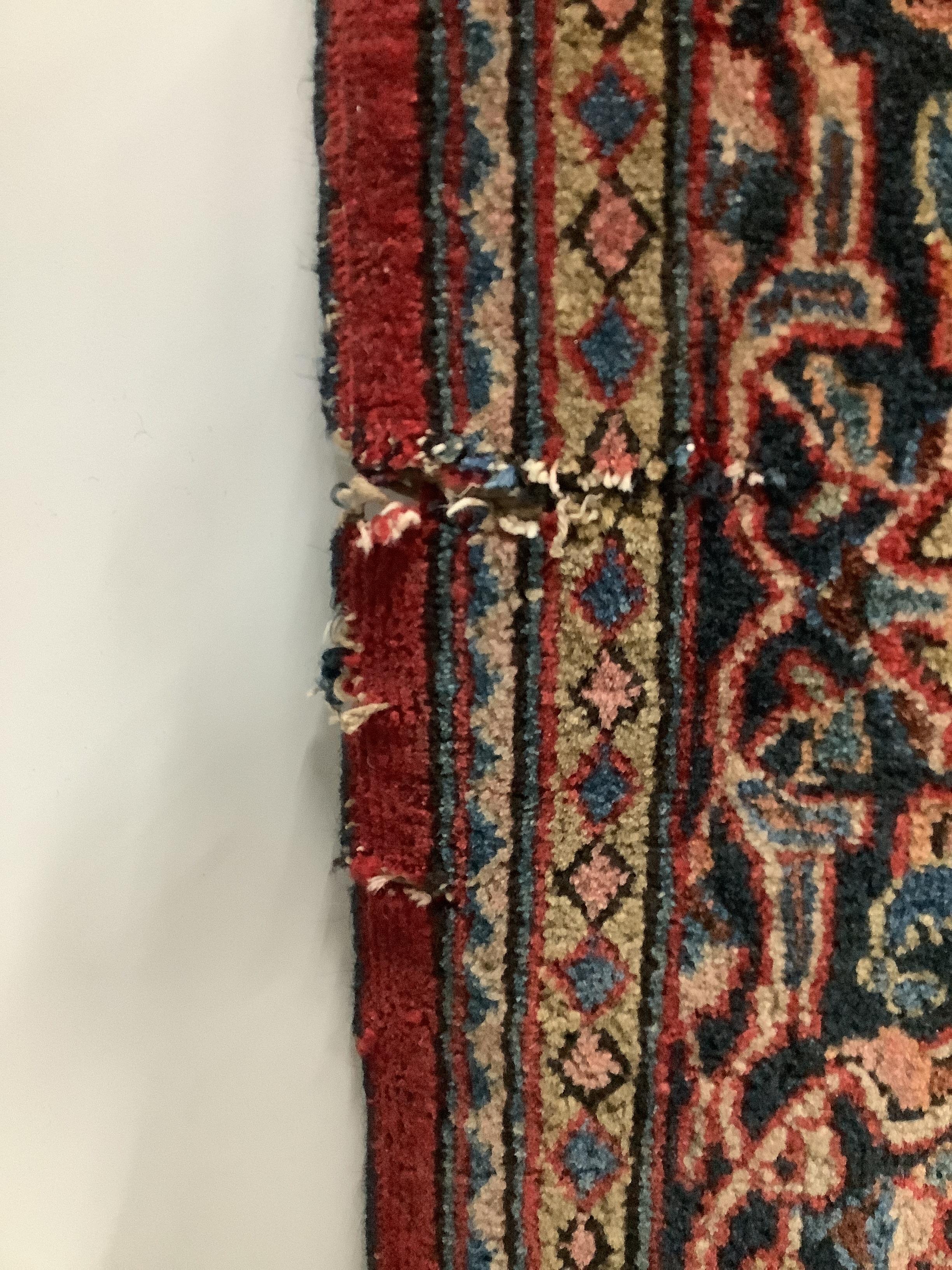 A Tabriz red ground rug, approximately 220 x 136cm